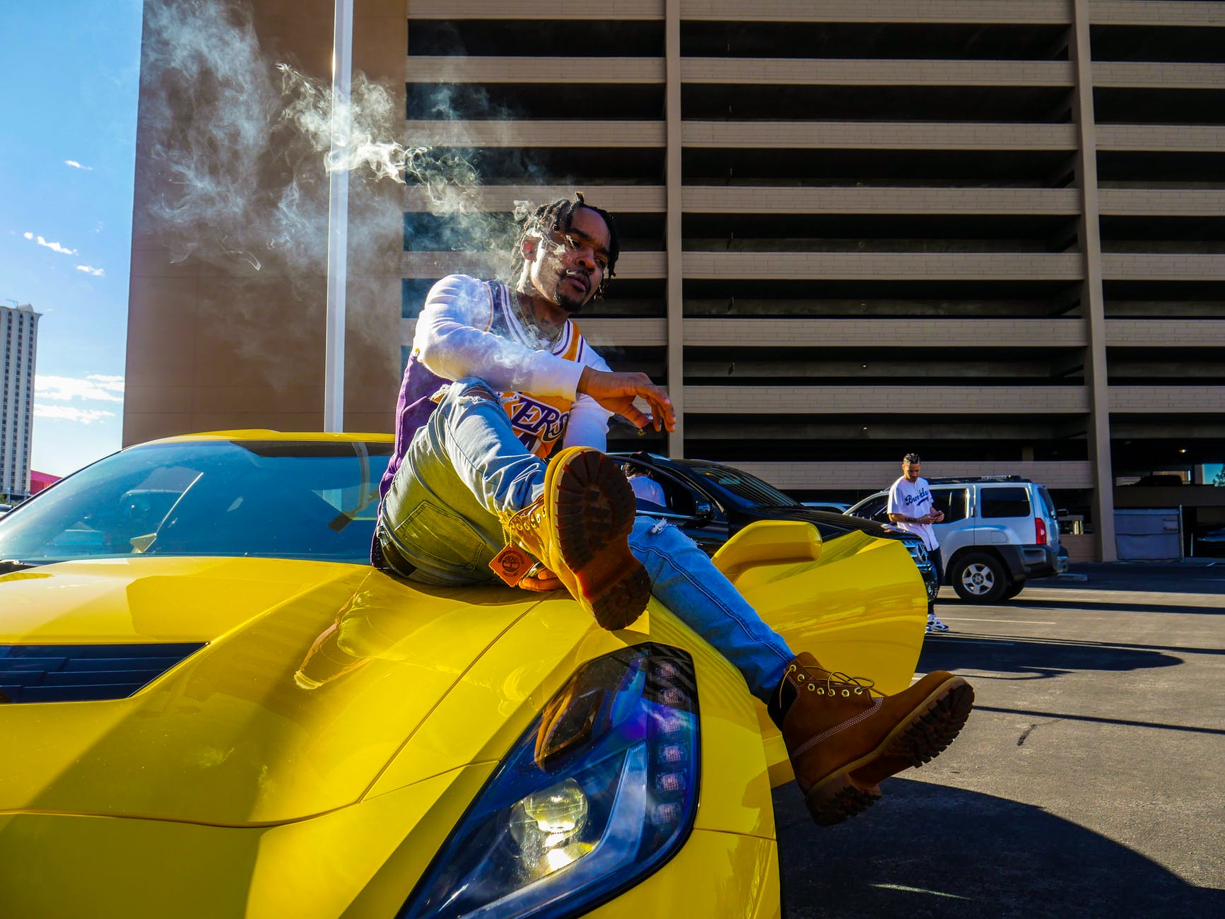 smoking man riding a yellow sports car