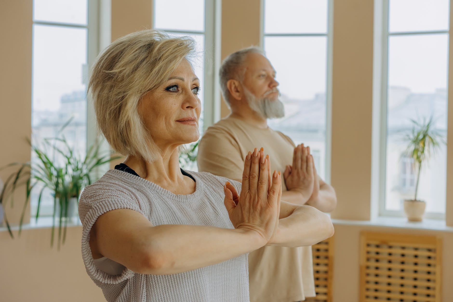 elderly man and woman doing yoga pose