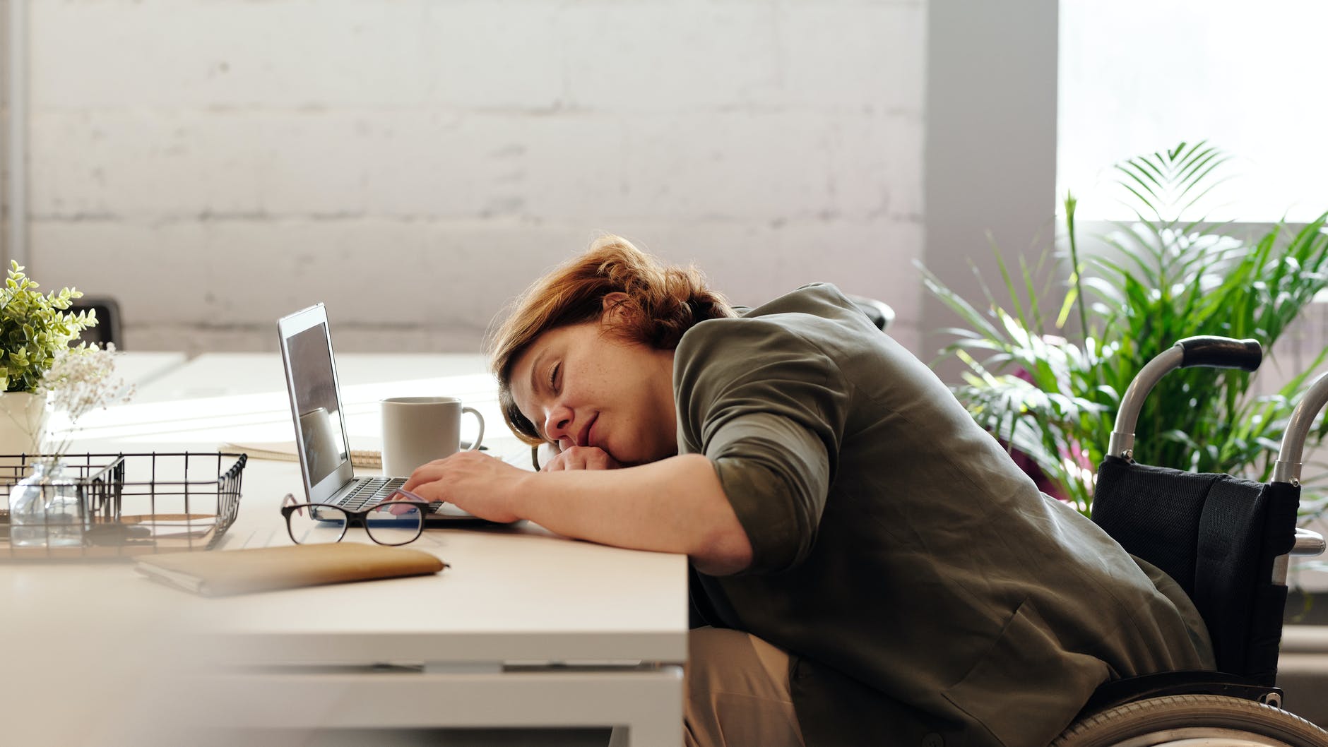 woman sleeping at her desk in the office