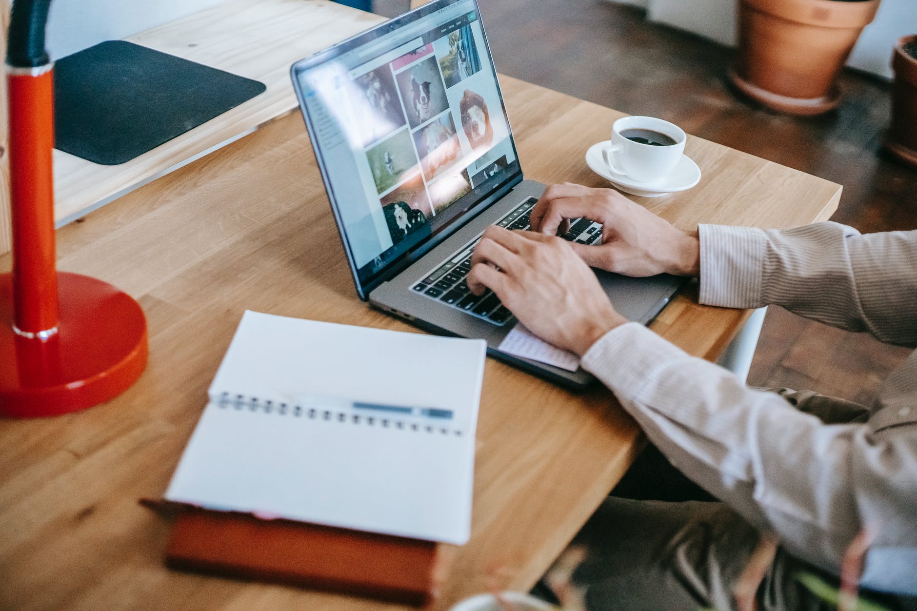A person using a laptop on a desk