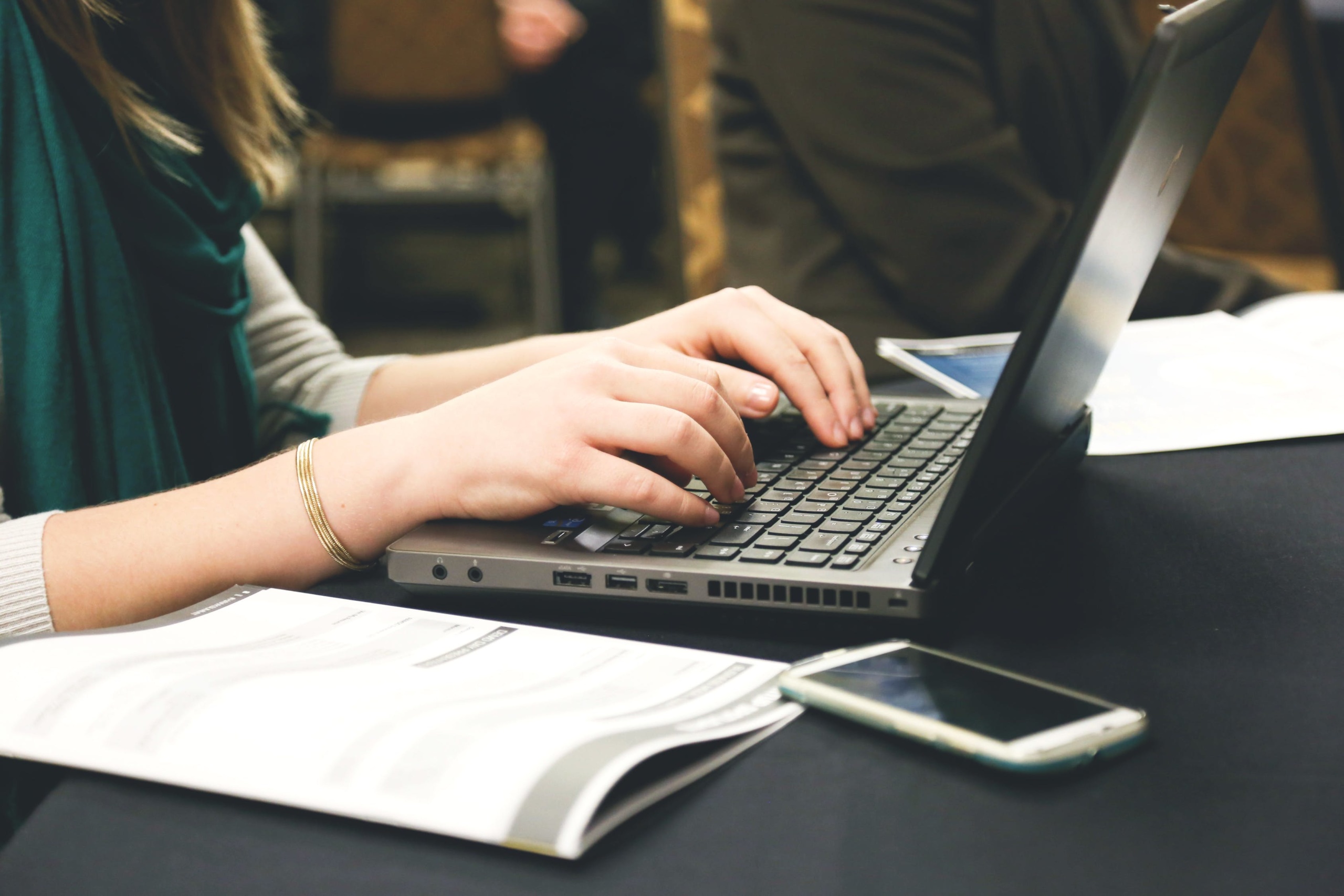 A woman typing on a laptop